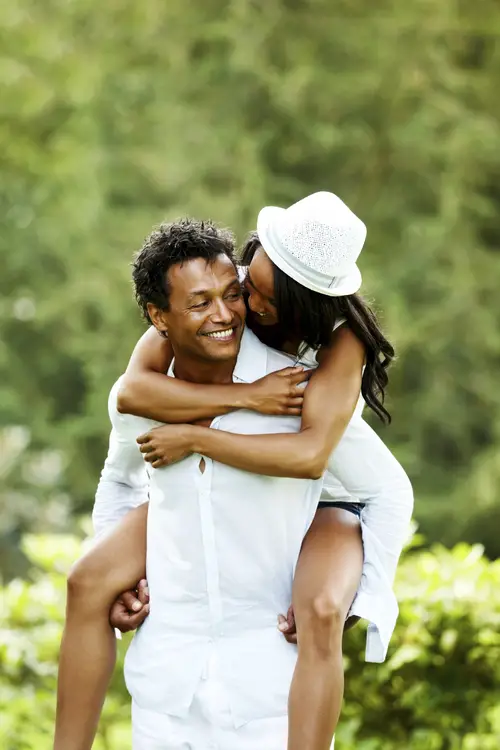 Handsome young man piggybacking his beautiful wife