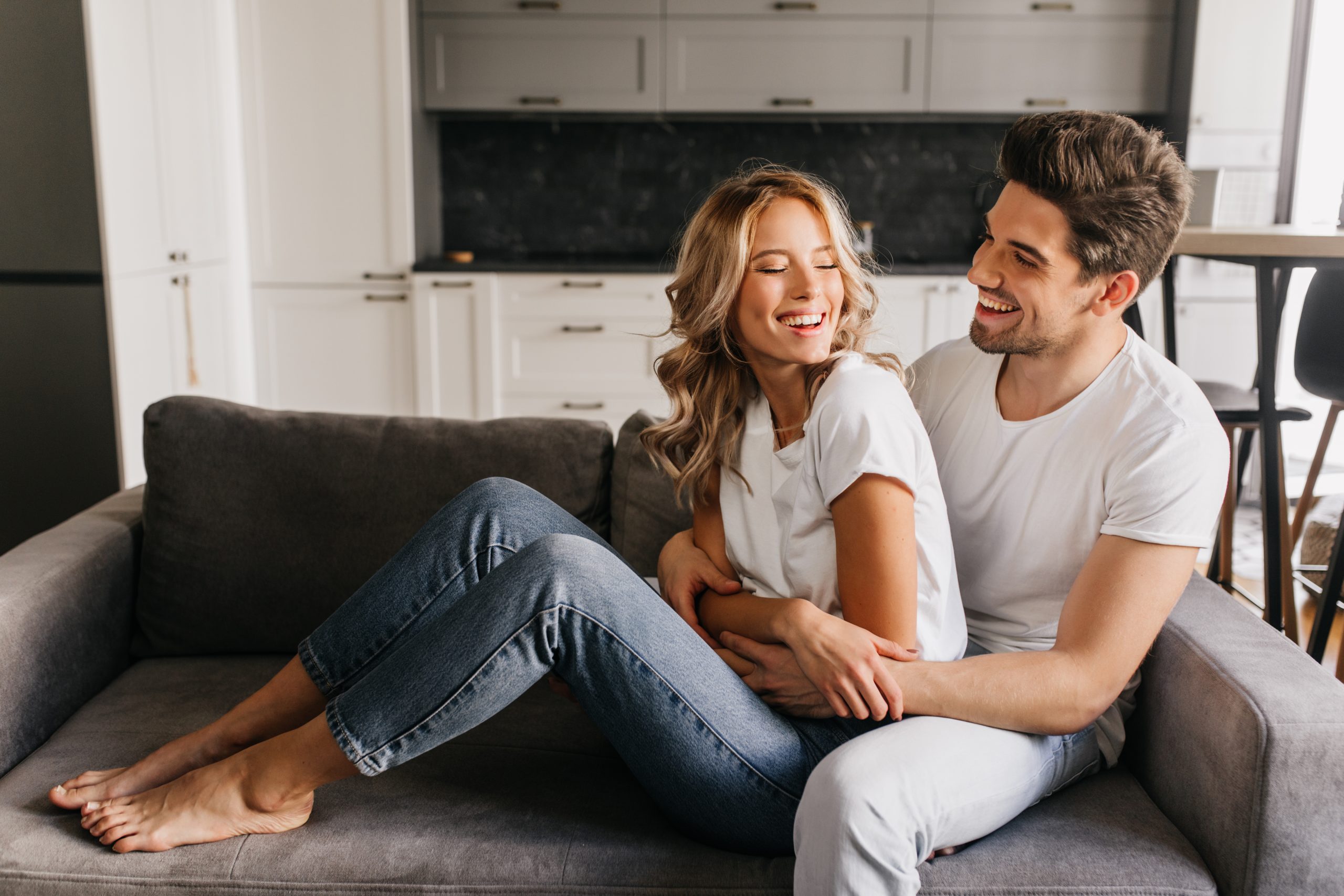 couple qui rit sur un canapé